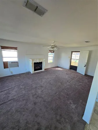 a view of a bedroom with a bed and wooden floor