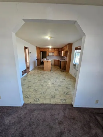 a large kitchen with stainless steel appliances a counter space and cabinets