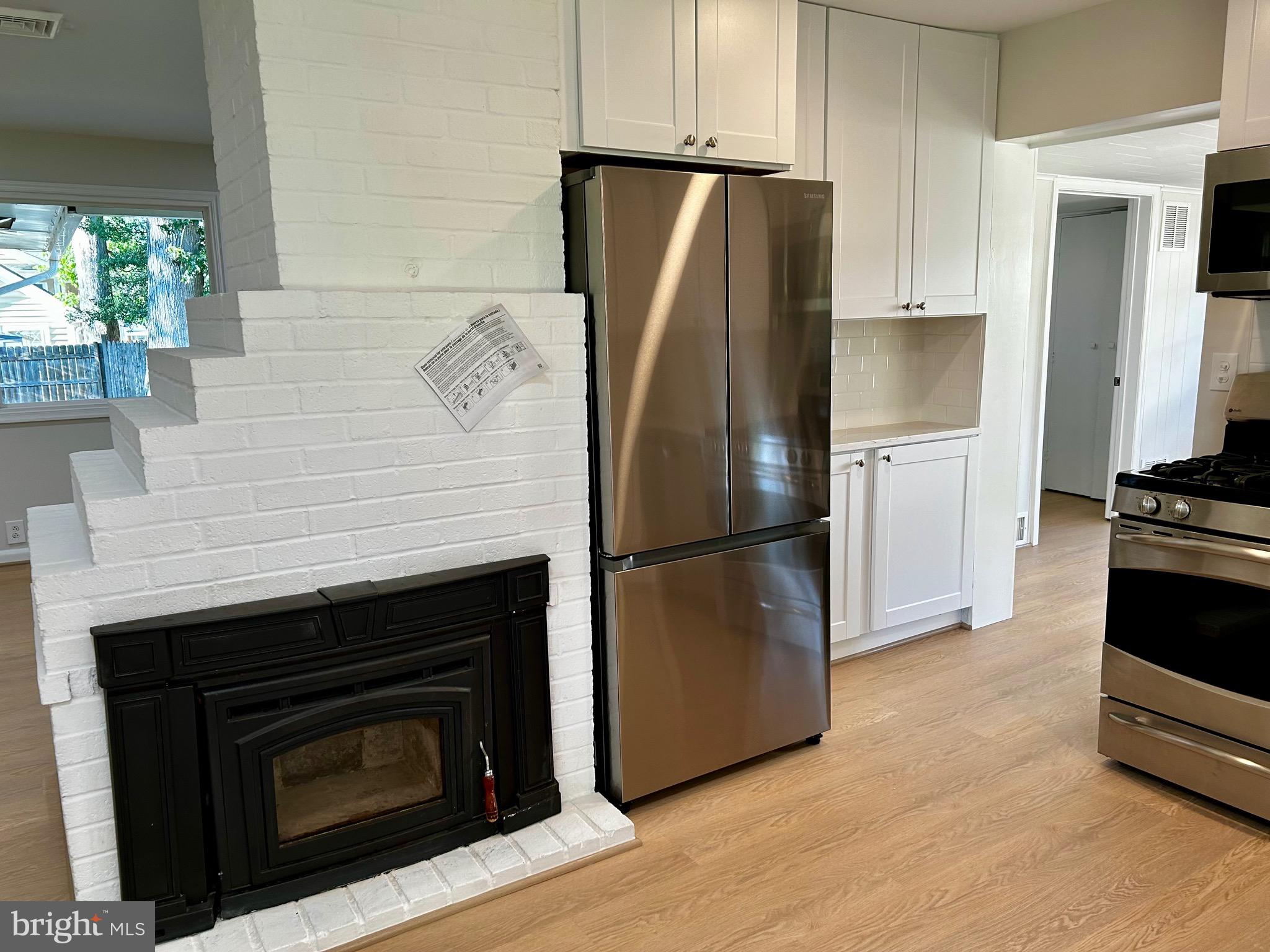7211 Halifax Place Springfield, VA 22150 - Photo 12 of 31 Two sided fireplace in kitchen and LR