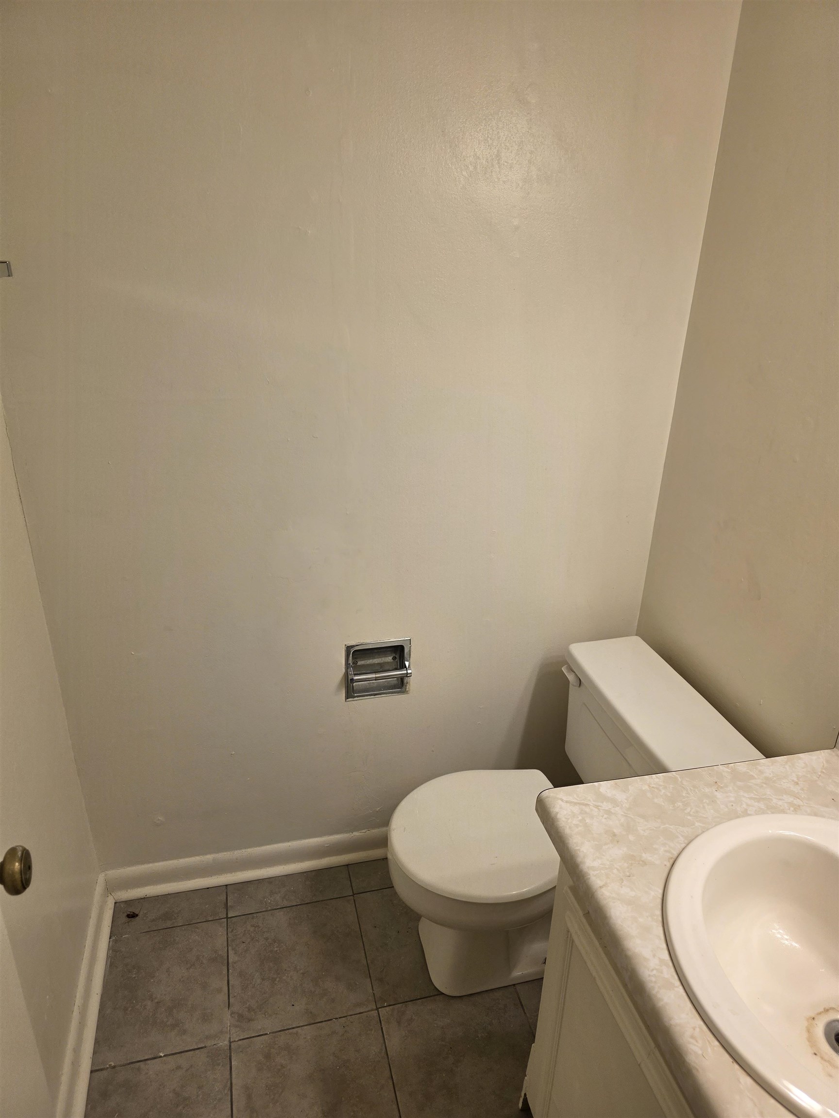 4729 Wild Plum Court, Unit 112 Memphis, TN 38118 - Photo 6 of 9 a white toilet sitting next to a white sink and vanity