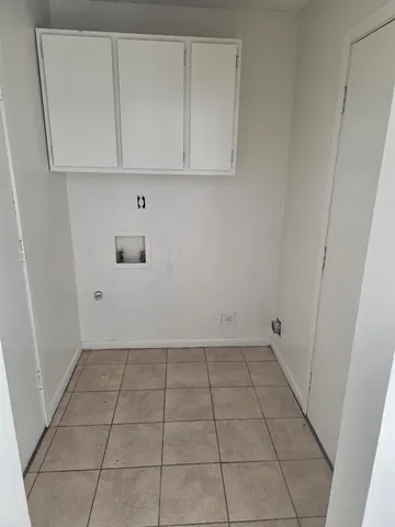 a view of a utility room with dishwasher and a window