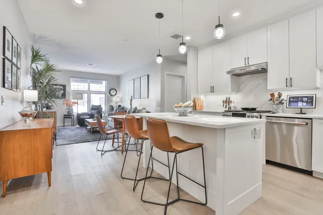 a kitchen with white cabinets and appliances