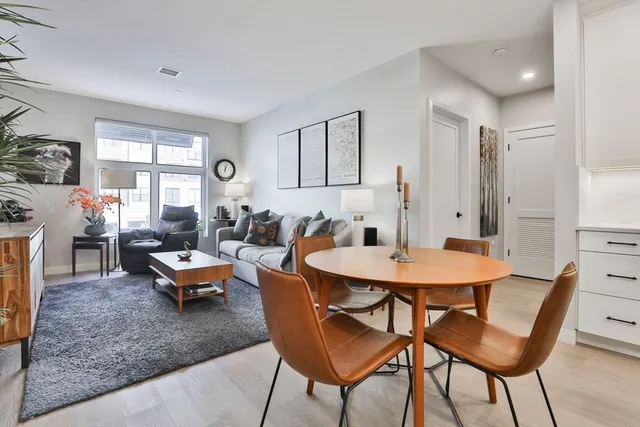 a view of a dining room with furniture and wooden floor