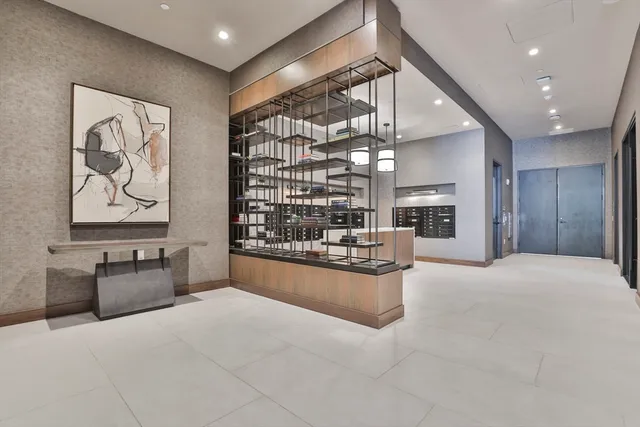 a large living room with stainless steel appliances kitchen island granite countertop a large window and kitchen view