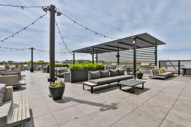 a building outdoor space with patio furniture and potted plants