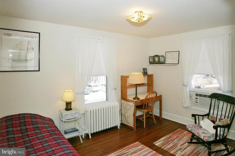 3602 Shepherd Street Chevy Chase, MD 20815 - Photo 7 of 12 a bedroom with a bed and wooden floor