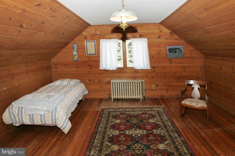3602 Shepherd Street Chevy Chase, MD 20815 - Photo 9 of 12 a bedroom with a bed and wooden floor