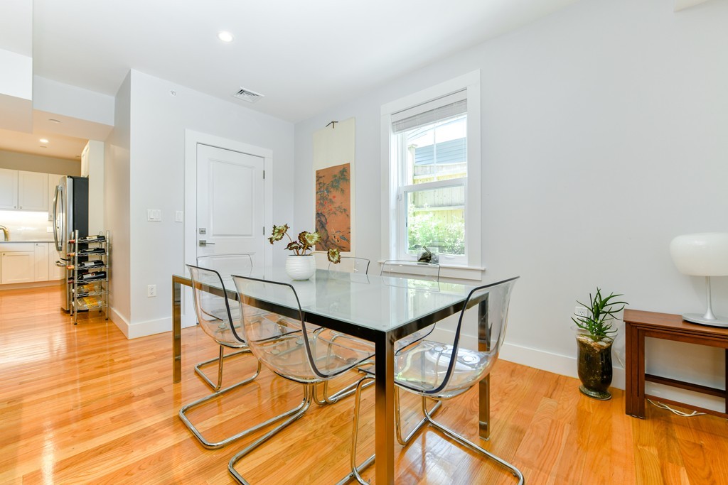 66 Wyman Street, Unit 1 Boston, MA 02130 - Photo 12 of 34 a view of a dining room with furniture and wooden floor