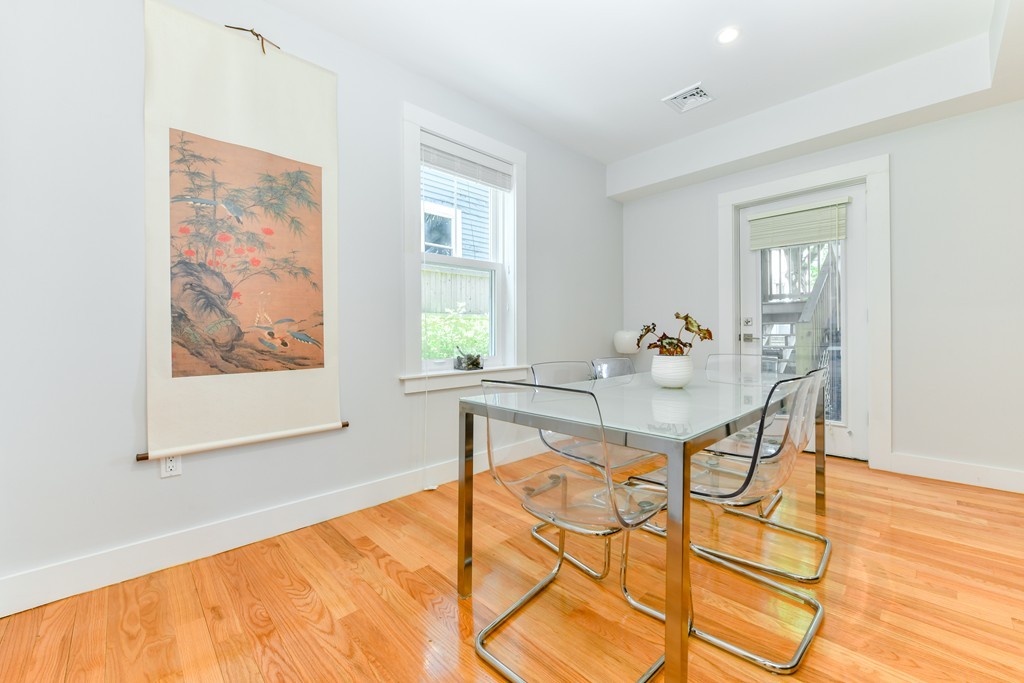 66 Wyman Street, Unit 1 Boston, MA 02130 - Photo 13 of 34 a view of a dining room with furniture and wooden floor