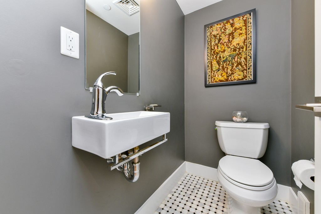 66 Wyman Street, Unit 1 Boston, MA 02130 - Photo 14 of 34 a bathroom with a toilet a sink and mirror