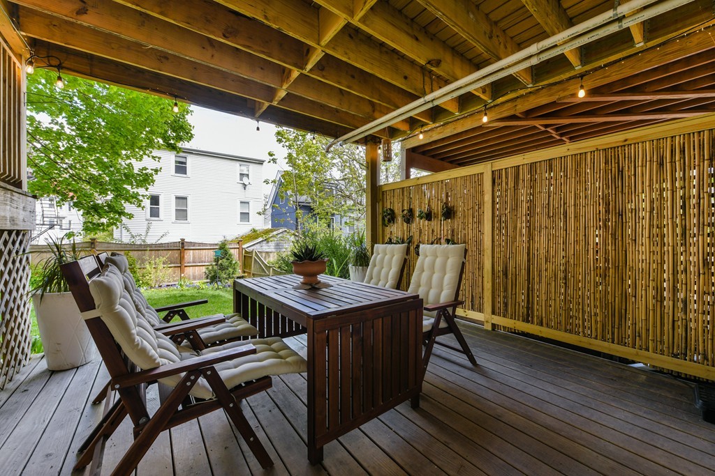 66 Wyman Street, Unit 1 Boston, MA 02130 - Photo 17 of 34 a view of a backyard with table and chairs