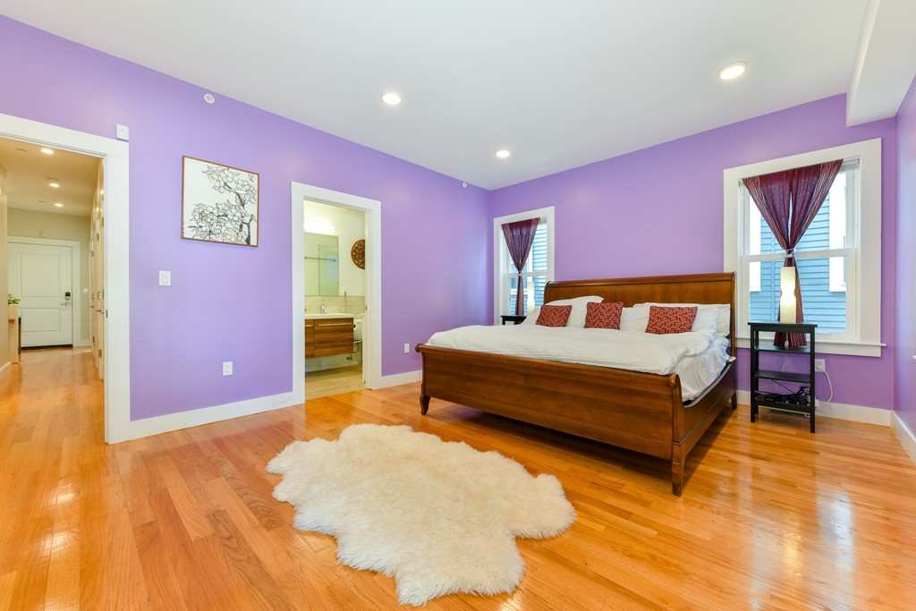 66 Wyman Street, Unit 1 Boston, MA 02130 - Photo 18 of 34 a bedroom with a bed and a table