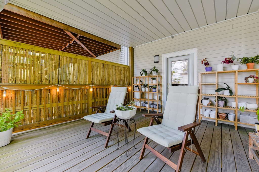 66 Wyman Street, Unit 1 Boston, MA 02130 - Photo 22 of 34 a balcony with wooden floor and outdoor seating