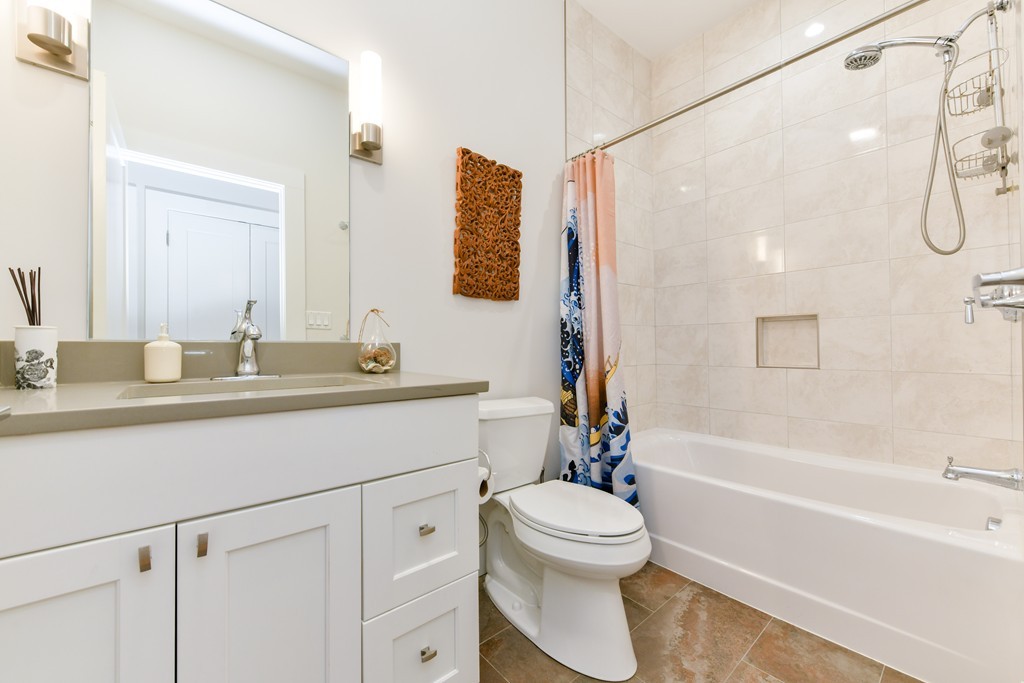 66 Wyman Street, Unit 1 Boston, MA 02130 - Photo 27 of 34 a bathroom with a sink a toilet and a bathtub