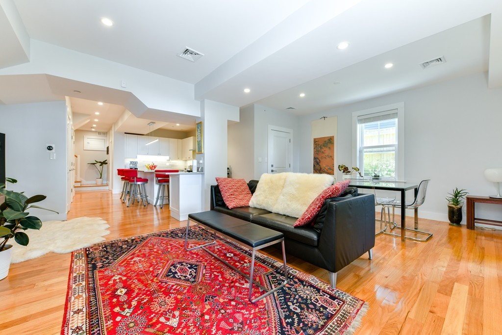 66 Wyman Street, Unit 1 Boston, MA 02130 - Photo 10 of 34 a living room with furniture and a wooden floor