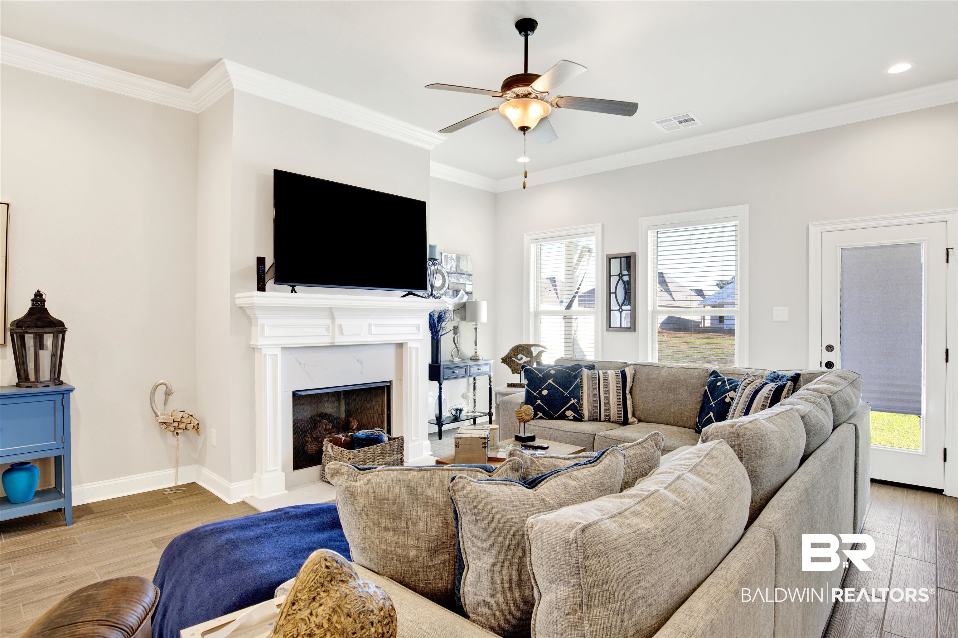 1406 Aldon Street Foley, AL 36535 - Photo 5 of 30 Living room featuring ceiling fan, ornamental molding, a fireplace, and luxury wood-look tile flooring.