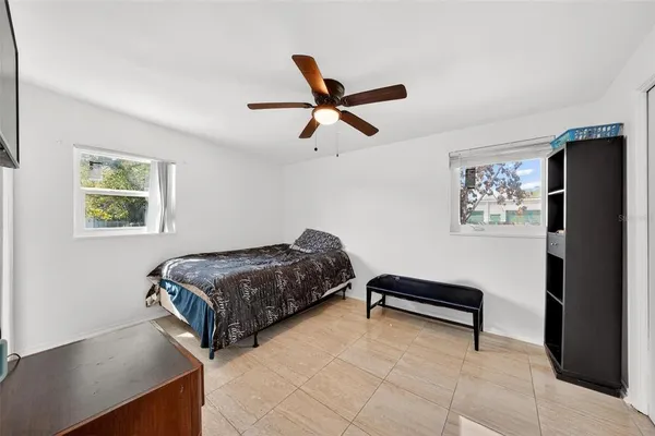 a bedroom with a bed and a chandelier