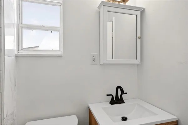 a bathroom with a sink and mirror