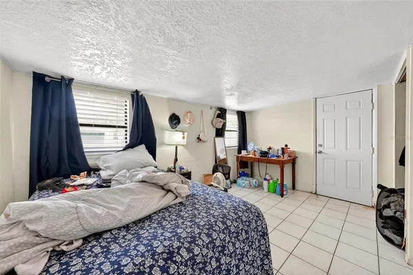 a bedroom that has a bed and a table in it