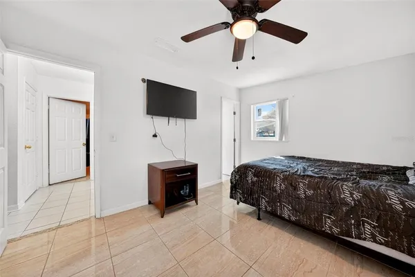 a bedroom with a bed and a television