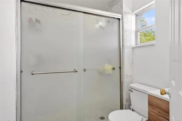 a white toilet sitting next to a bathroom sink