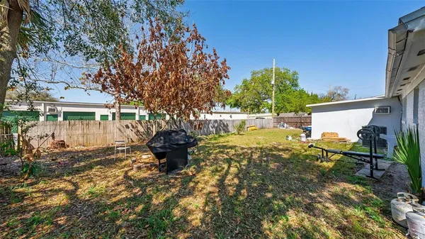 a view of a house with backyard and sitting area