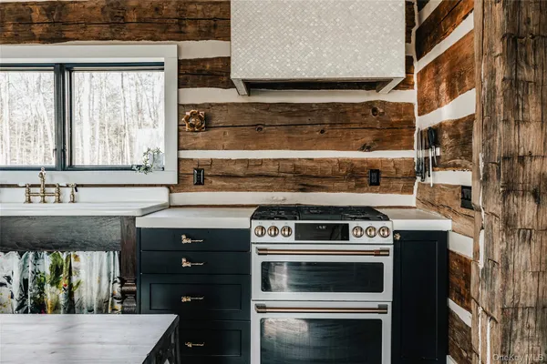 a living room with fireplace furniture and a large window