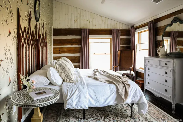 a bed sitting in a bedroom next to a window