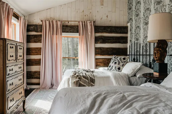 a bedroom with bed and a night stand