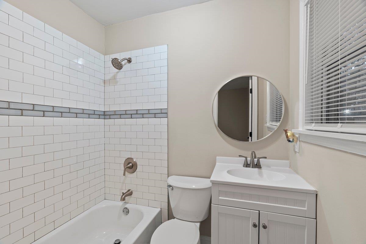 1042 East Alcy Road Memphis, TN 38106 - Photo 4 of 24 a bathroom with a toilet sink vanity tub and shower