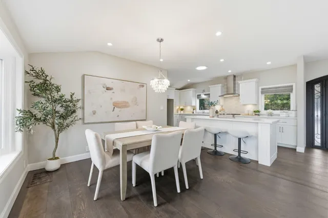 a bathroom with a granite countertop sink toilet a mirror and shower