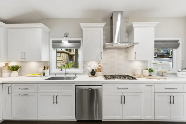 a living room with furniture large window and wooden floor