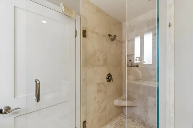 a backyard of a house with table and chairs with wooden fence