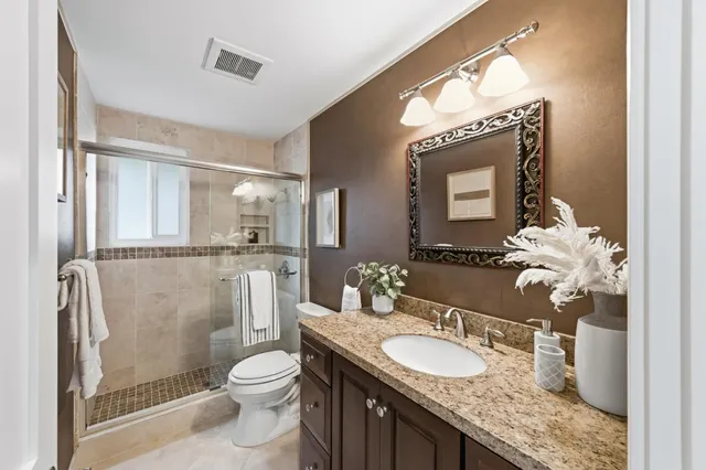 an aerial view of a house with yard swimming pool and ocean view