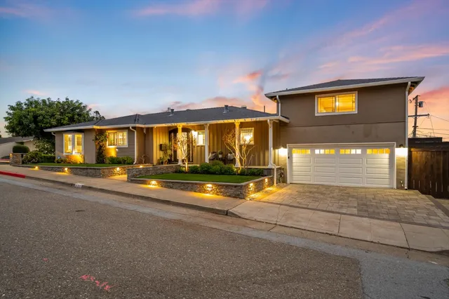 a front view of a house with garden
