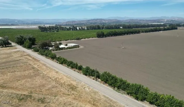 an aerial view of a house with a garden and lake view