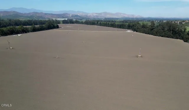 a view of a yard with wooden fence
