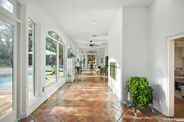 a view of a hallway with furniture and a porch