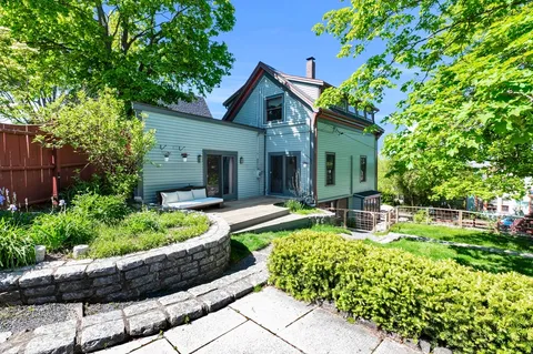 a front view of house with yard and outdoor seating