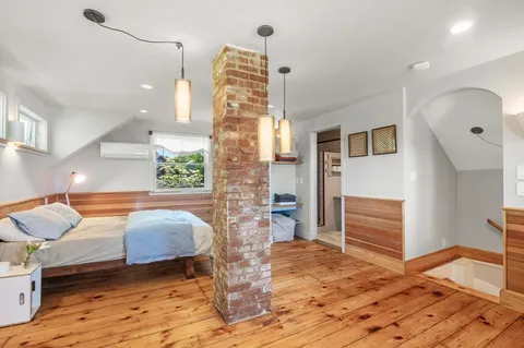a bedroom with furniture and a wooden floor
