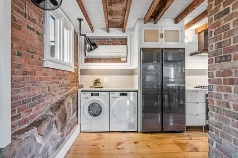 a view of a door of a house with a washer and dryer