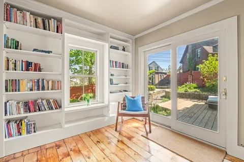 a living room with furniture and a book shelf