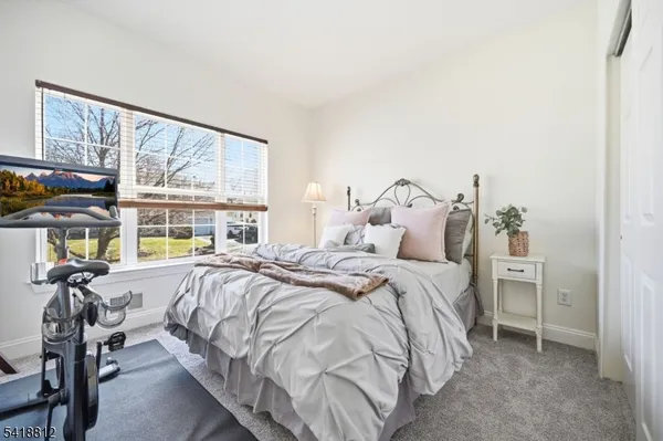 a kitchen with stainless steel appliances granite countertop a refrigerator a stove a sink a dining table and chairs with wooden floor