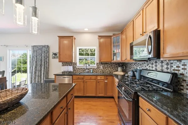 a living room with furniture fireplace and a large window