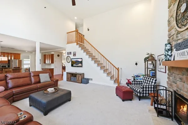a utility room with dryer washer and a view of living room