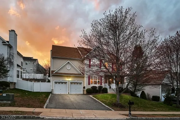a living room with furniture wooden floor and a large window