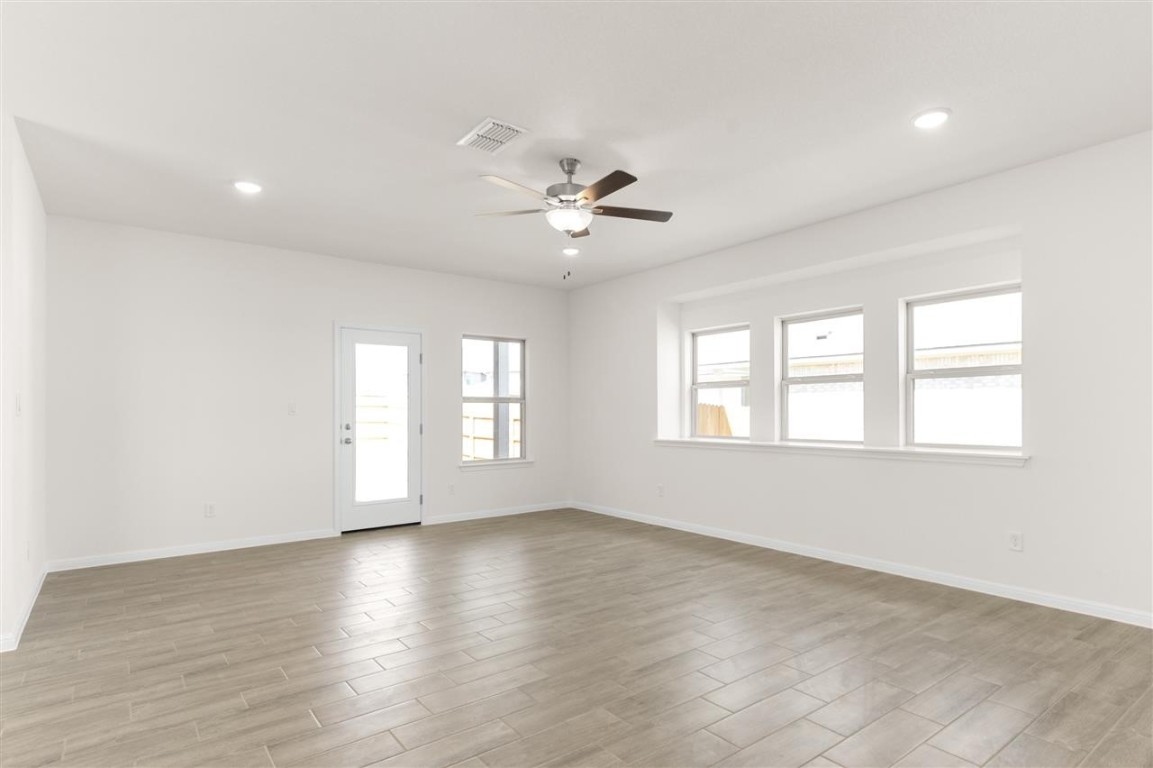 709 Paddock Lane Georgetown, TX 78626 - Photo 13 of 35 wooden floor in an empty room with a window