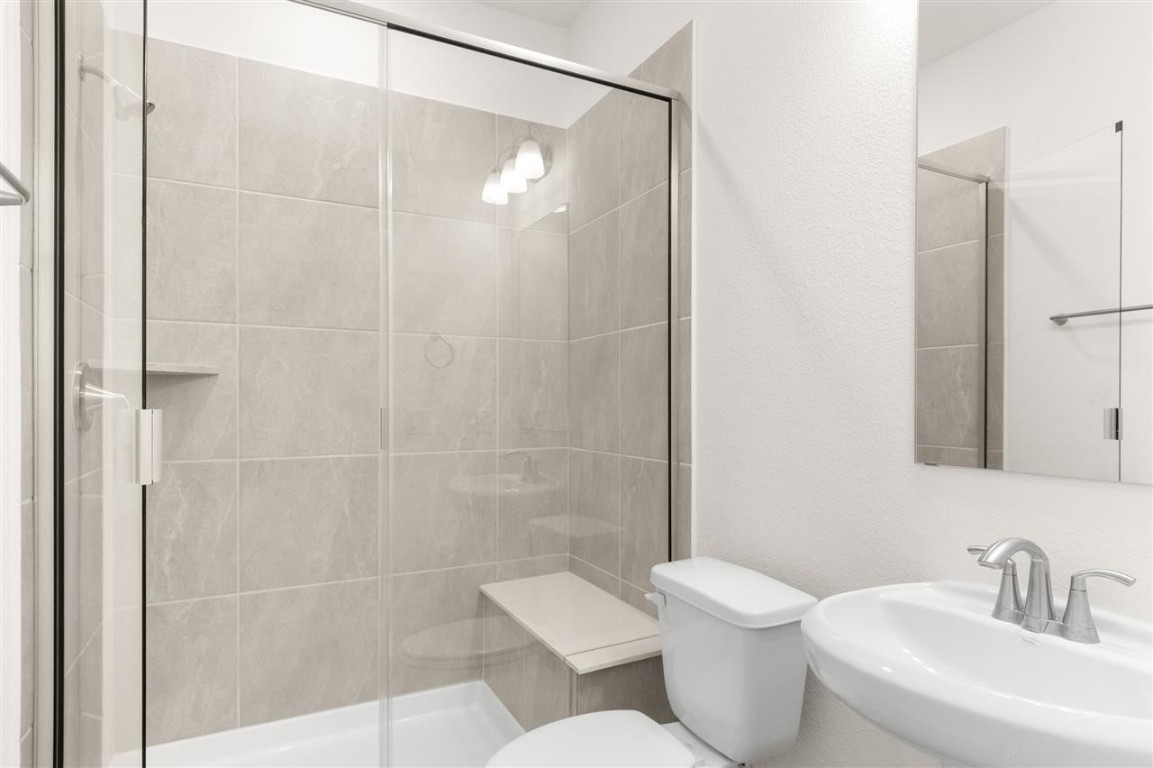 709 Paddock Lane Georgetown, TX 78626 - Photo 17 of 35 a bathroom with a toilet sink and shower