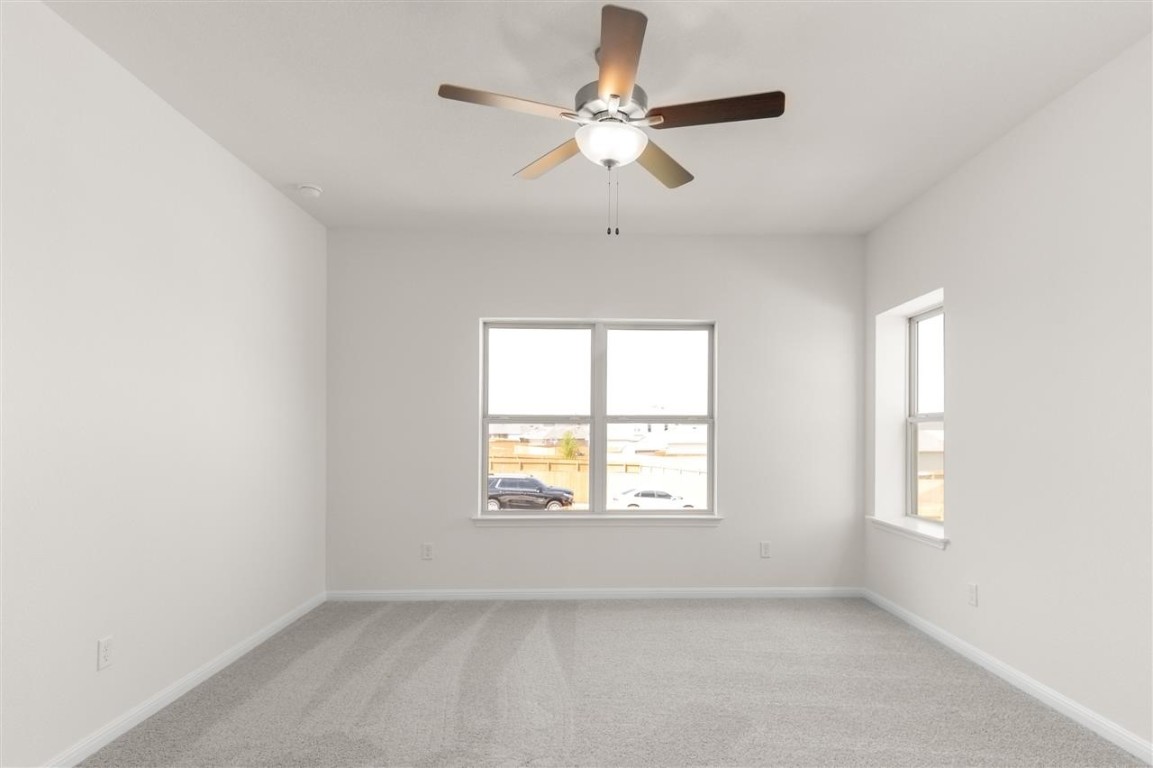 709 Paddock Lane Georgetown, TX 78626 - Photo 22 of 35 an empty room with windows and fan