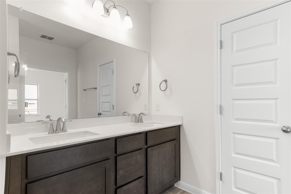 709 Paddock Lane Georgetown, TX 78626 - Photo 25 of 35 a bathroom with a double vanity sink mirror and